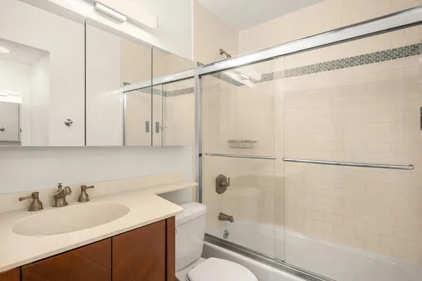 a bathroom with a sink toilet and shower