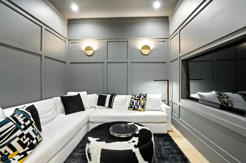 a bedroom with a bed and large window with balcony view