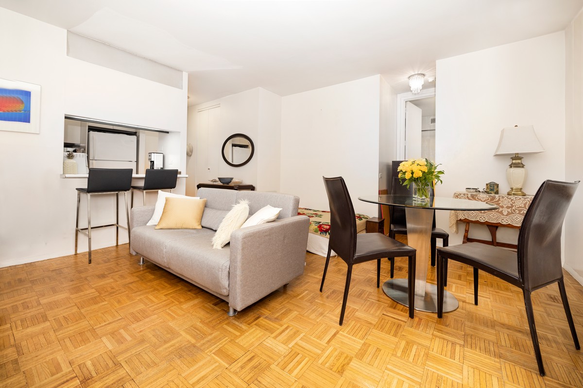 250 West 89th Street, Unit 5A Manhattan, NY 10024 - Photo 2 of 8 a living room with furniture and wooden floor
