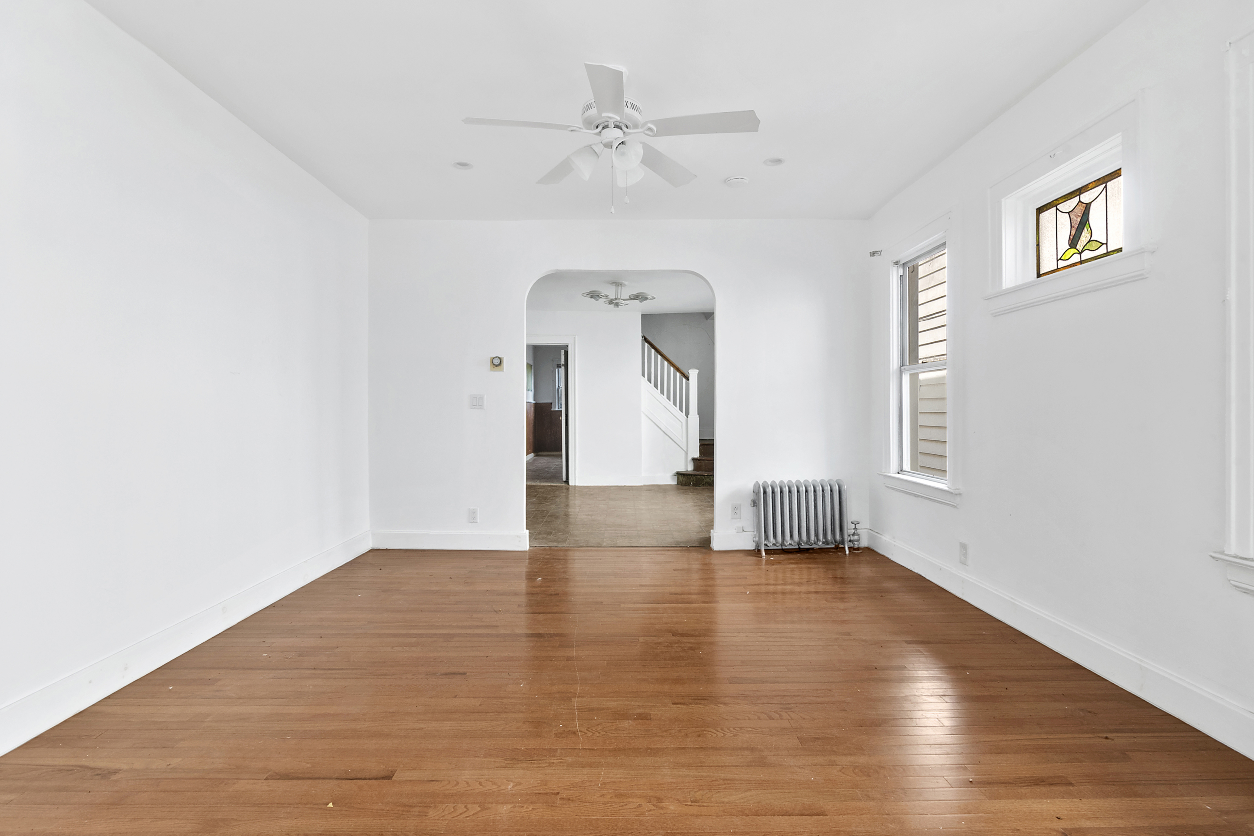 266 East 43rd Street Brooklyn, NY 11203 - Photo 5 of 11 a view of an empty room with a window and wooden floor