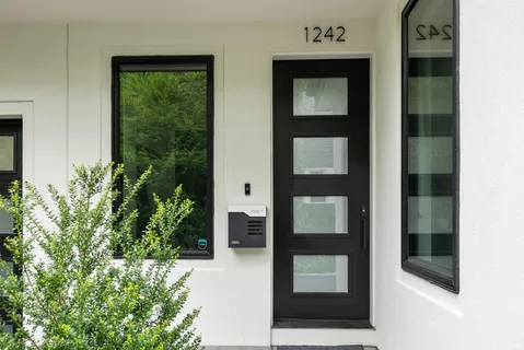 a large kitchen with stainless steel appliances lots of counter space sink and a large window