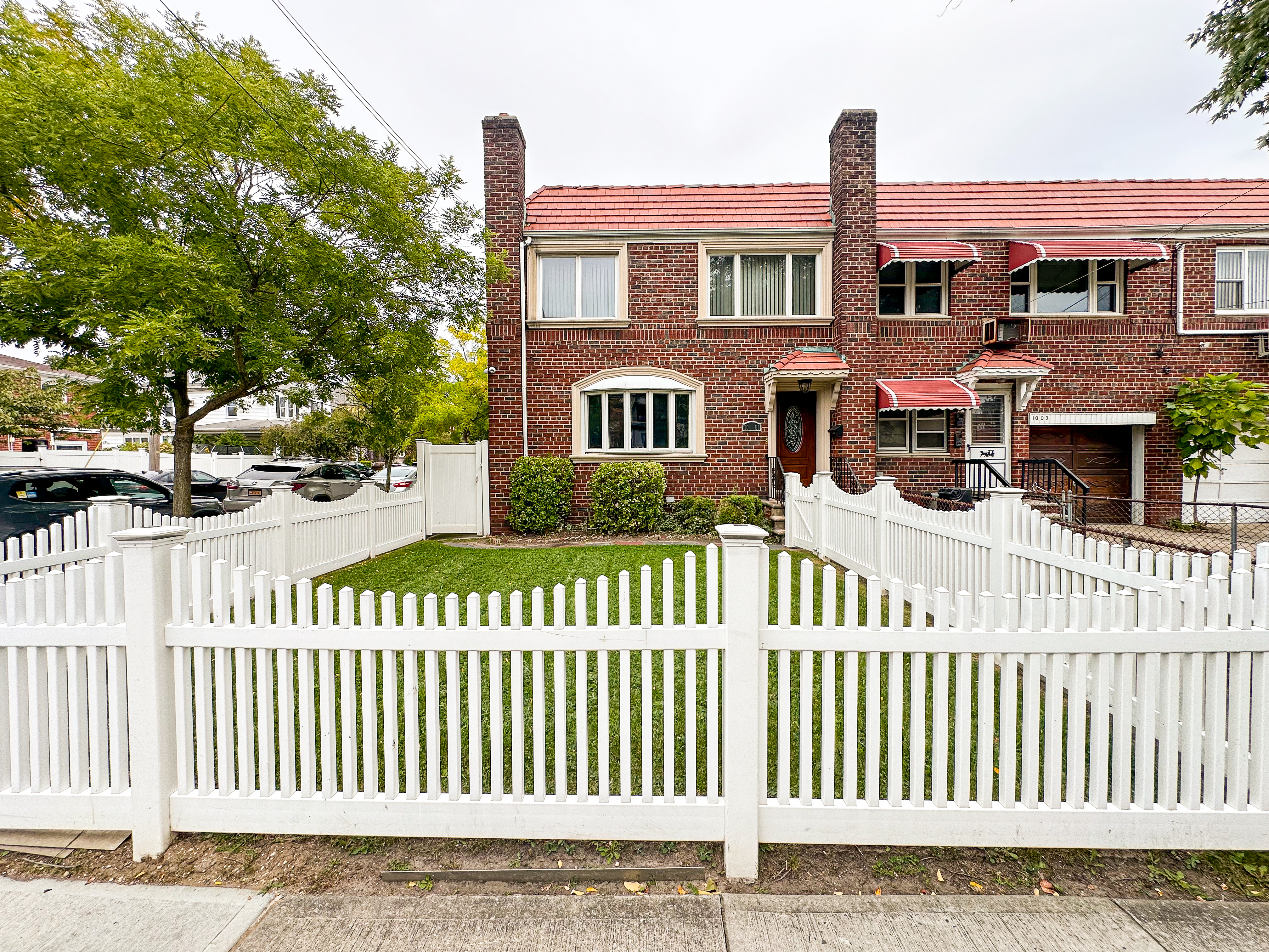 10-01 154th Street, Unit 1 Queens, NY 11357 - Photo 10 of 10 a front view of a house with a garden