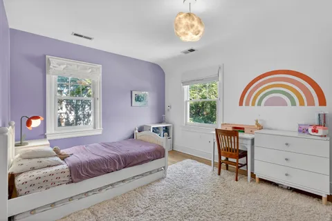 a spacious bedroom with a bed and a flat screen tv