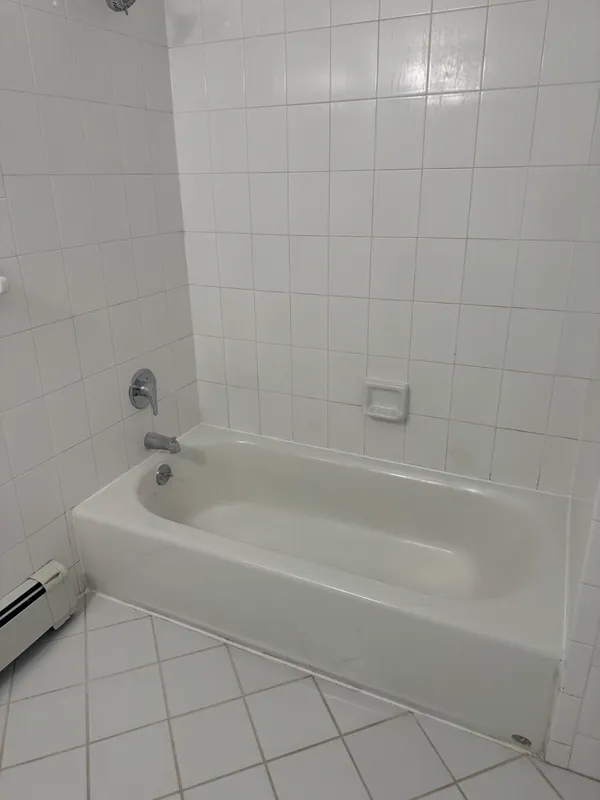 a white bath tub sitting next to a white sink