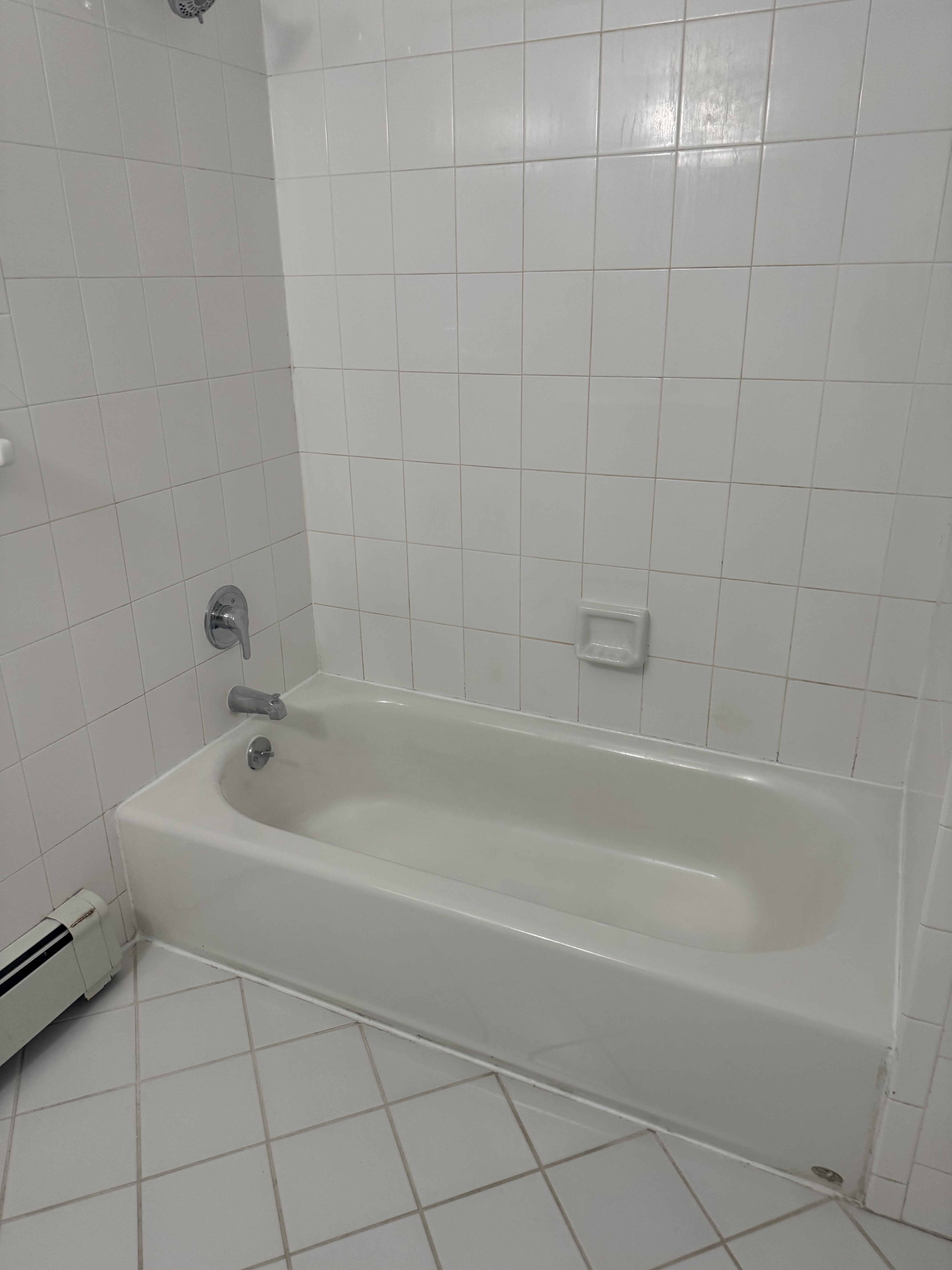 39-46 59th Street, Unit 1 Queens, NY 11377 - Photo 5 of 6 a white bath tub sitting next to a white sink