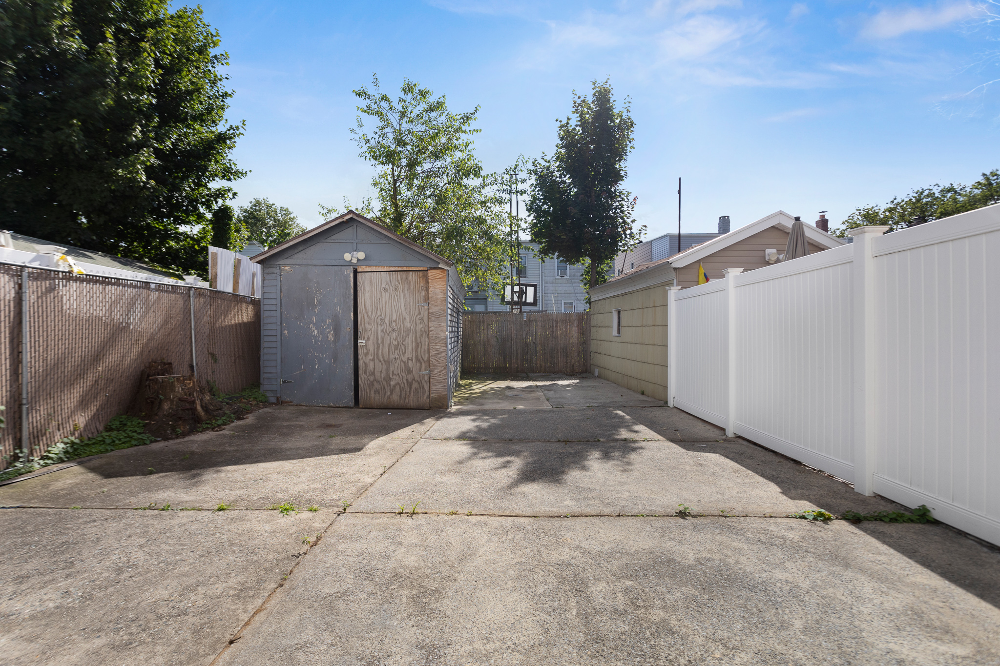 91-22 92nd Street Queens, NY 11421 - Photo 20 of 27 a front view of a house with a yard and garage