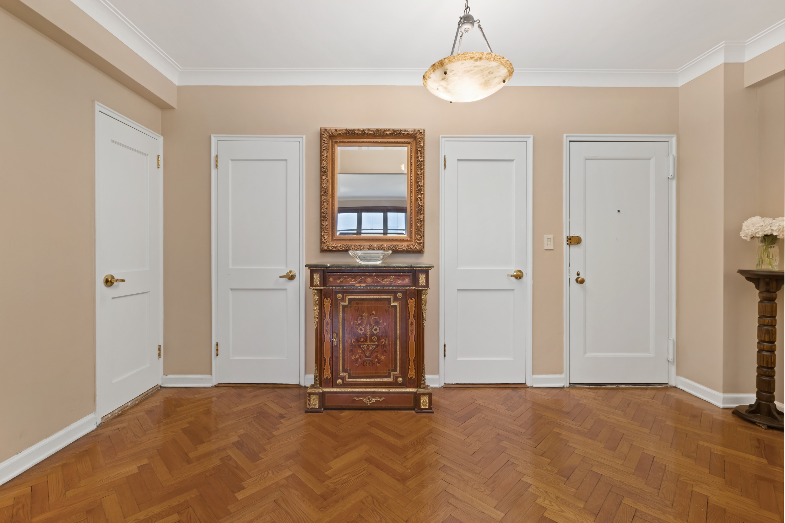 710 Park Avenue, Unit 5F Manhattan, NY 10021 - Photo 5 of 11 an empty room with windows and cabinet