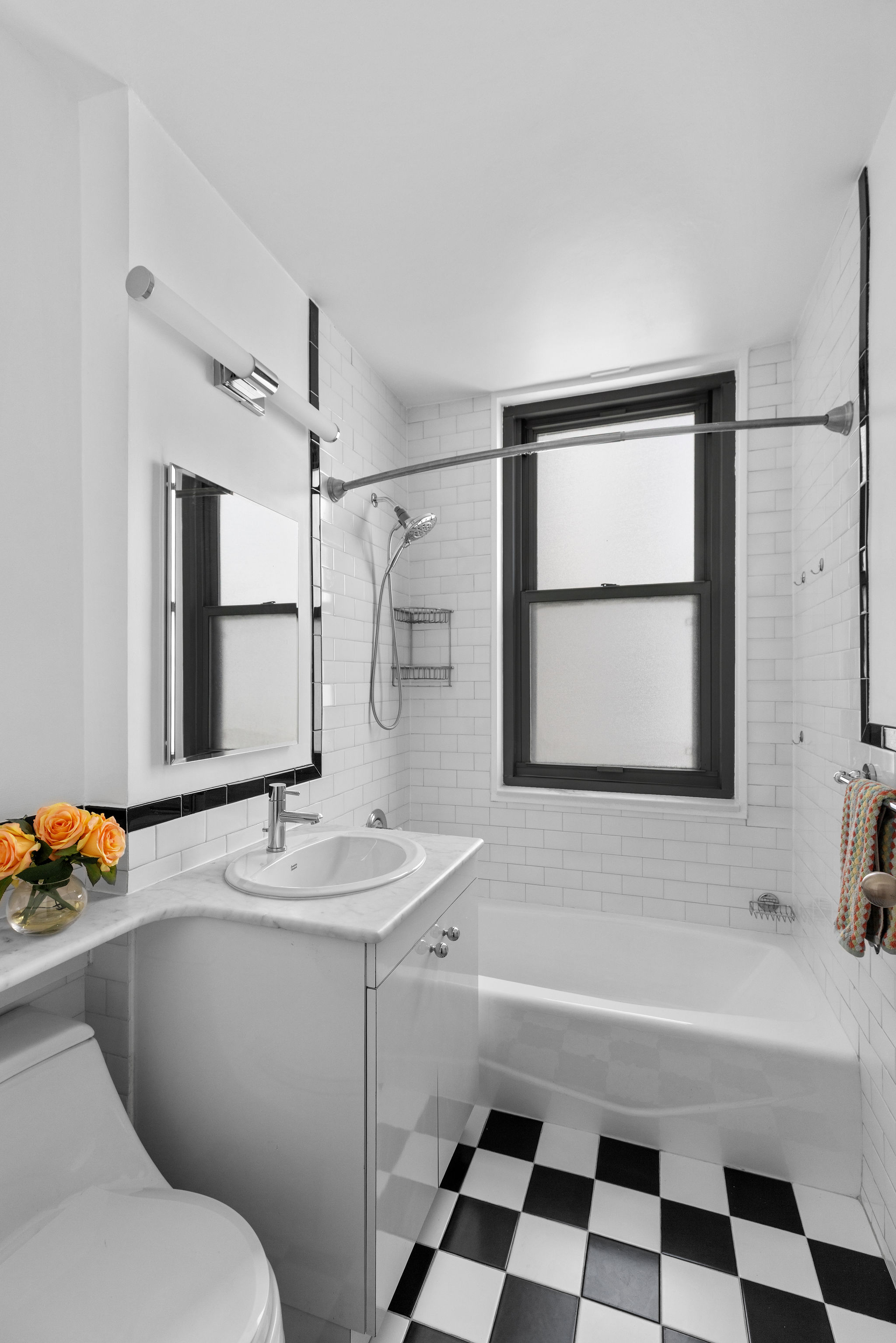 2025 Broadway, Unit 5A Manhattan, NY 10023 - Photo 5 of 13 a bathroom with a sink a toilet and shower