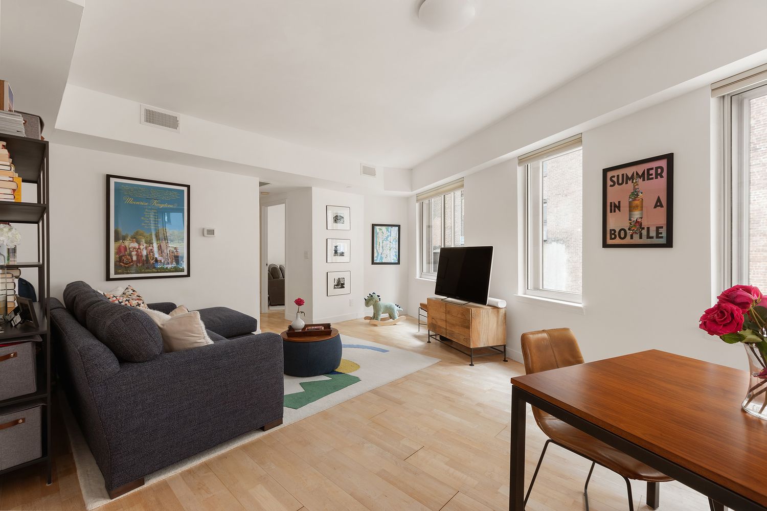 a living room with furniture a couch and a flat screen tv