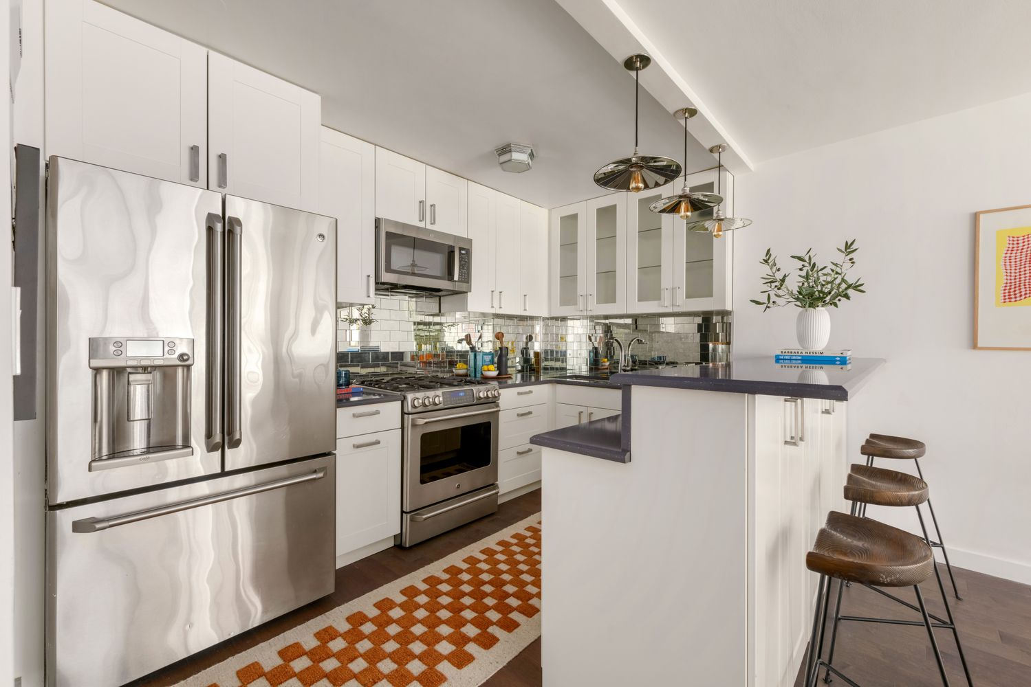 a kitchen with stainless steel appliances a refrigerator sink and stove