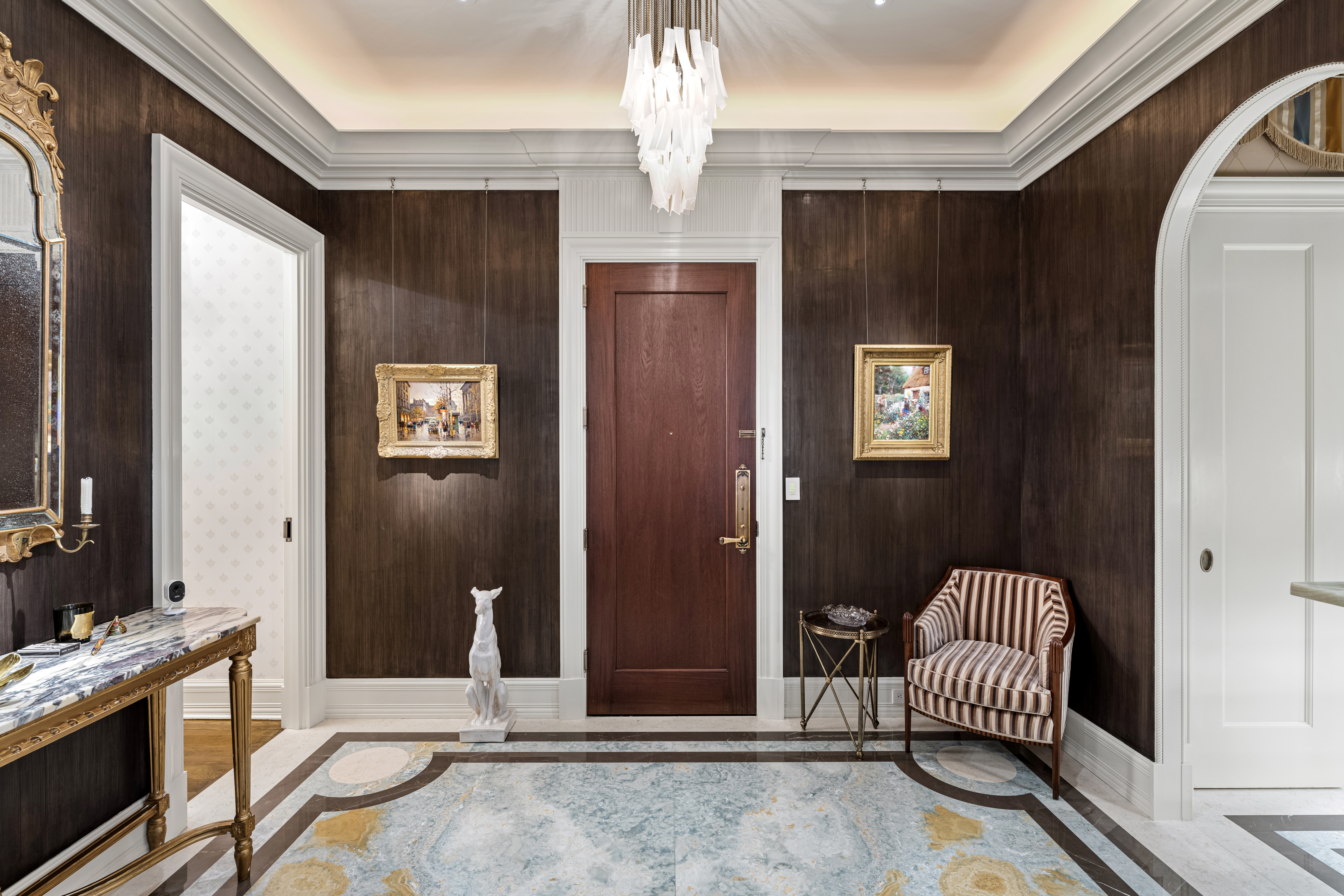 1 Central Park South, Unit 1013 Manhattan, NY 10019 - Photo 17 of 32 a spacious bedroom with a bed and a chandelier