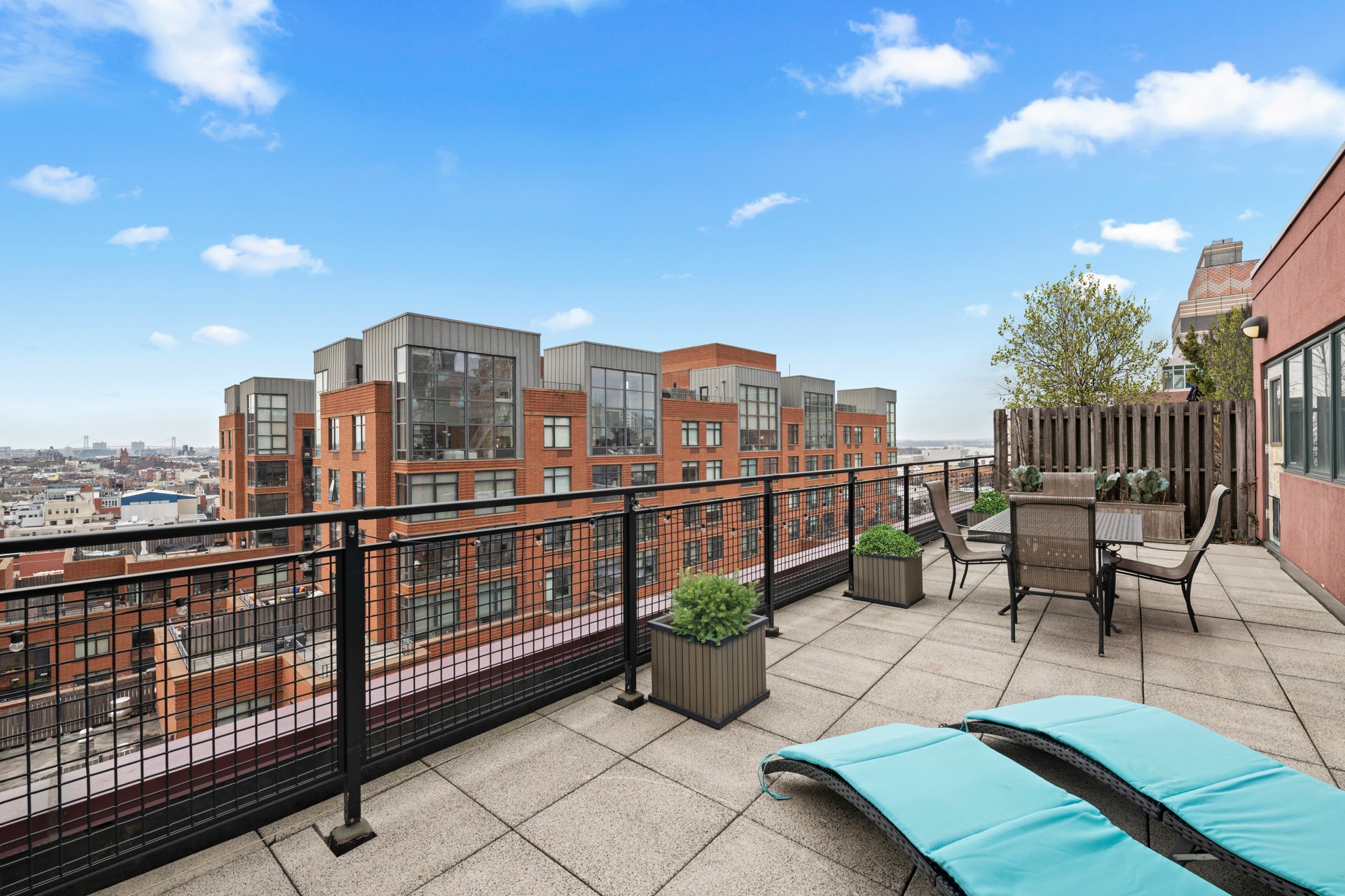 a view of city from balcony with seating space