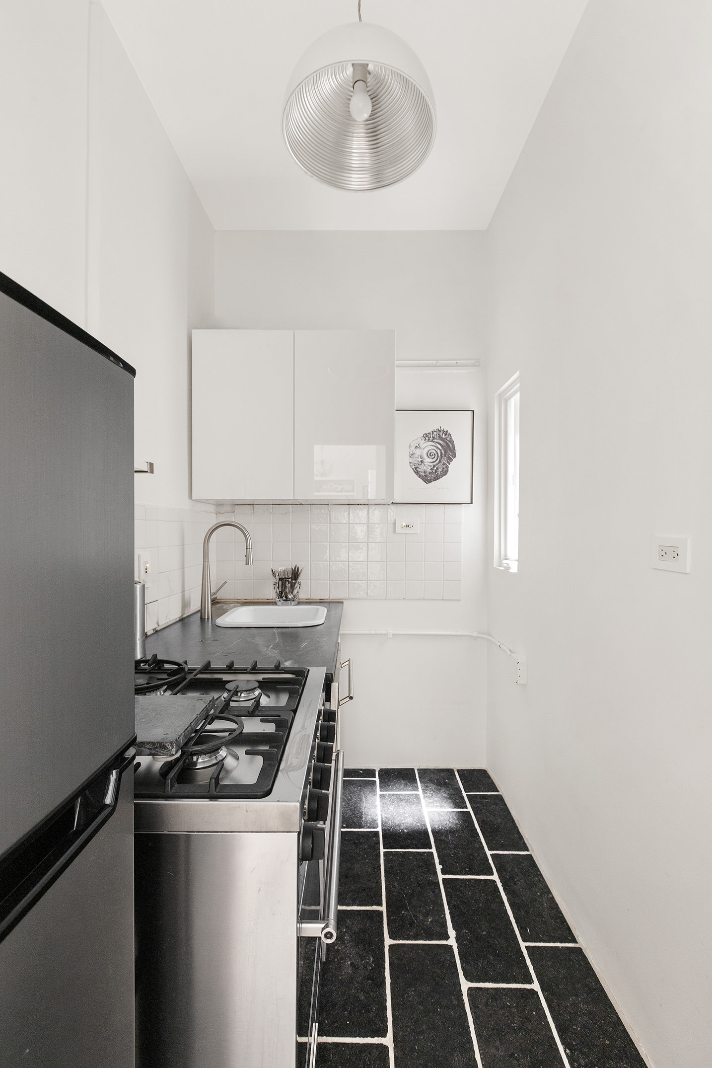 525 East 84th Street, Unit 3B Manhattan, NY 10028 - Photo 5 of 10 a white stove top oven sitting inside of a kitchen