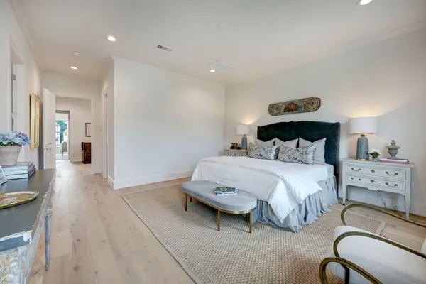 a spacious bedroom with a bed and a view of bathroom