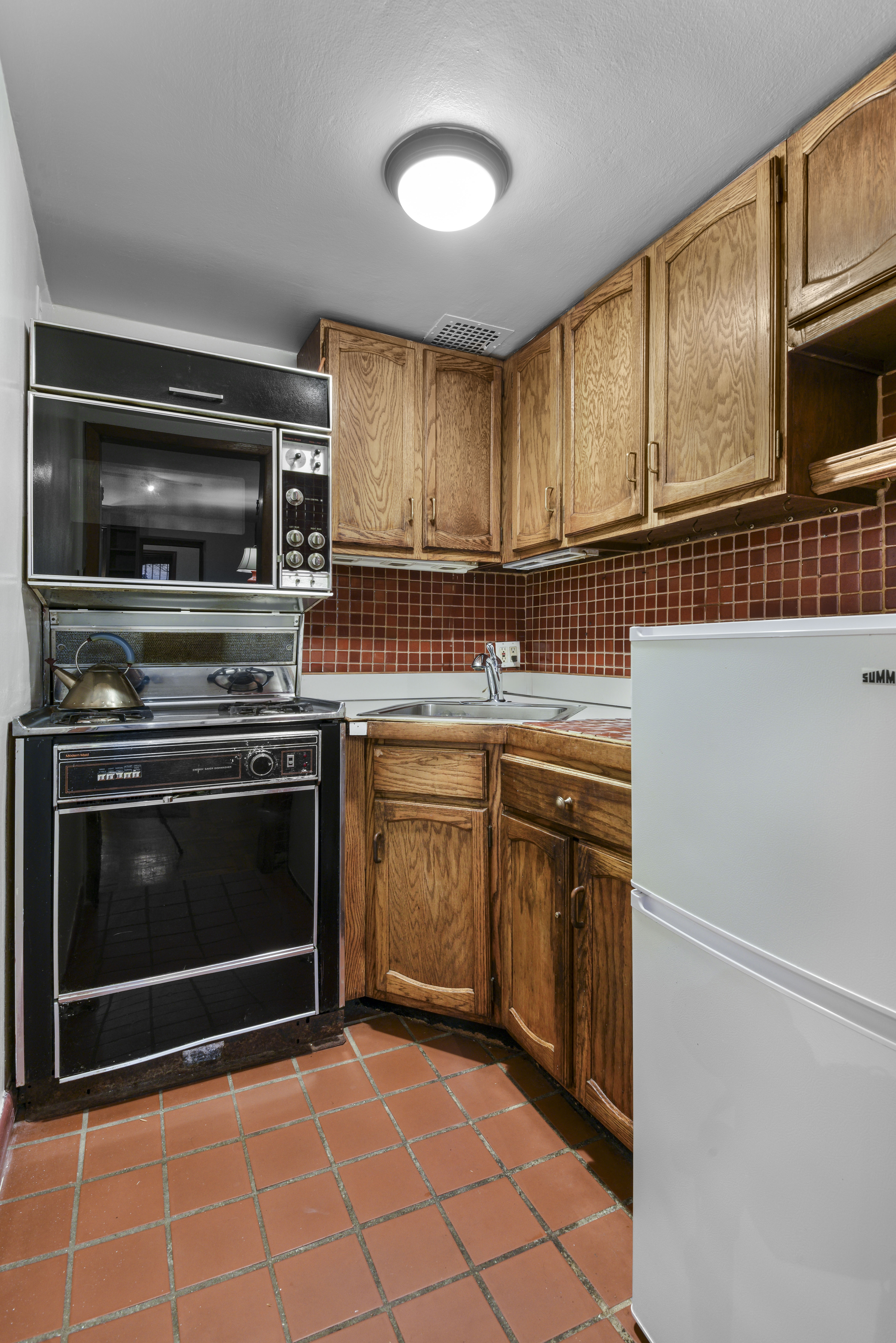 146 West 80th Street, Unit BR Manhattan, NY 10024 - Photo 14 of 16 a kitchen with a stove and a microwave