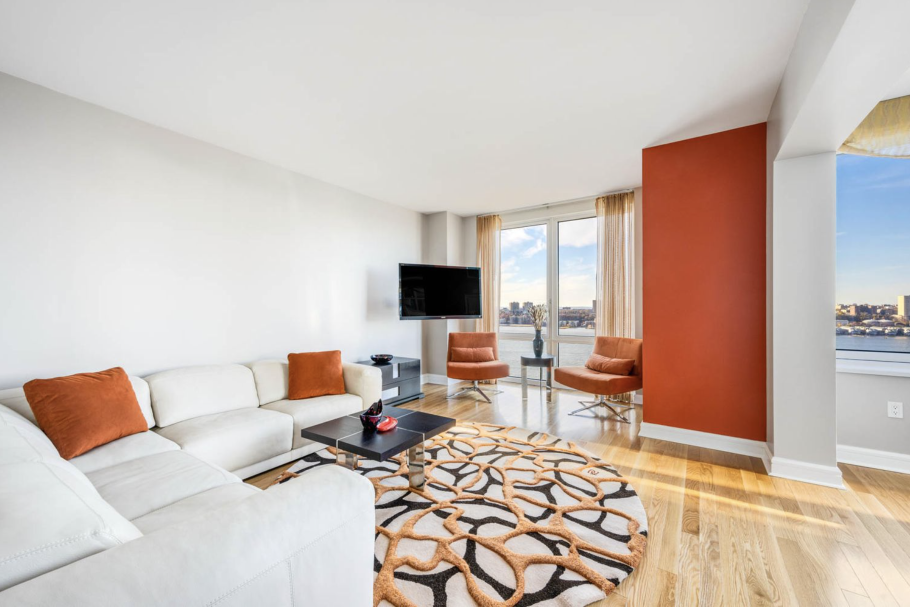 a bedroom with furniture and a flat screen tv