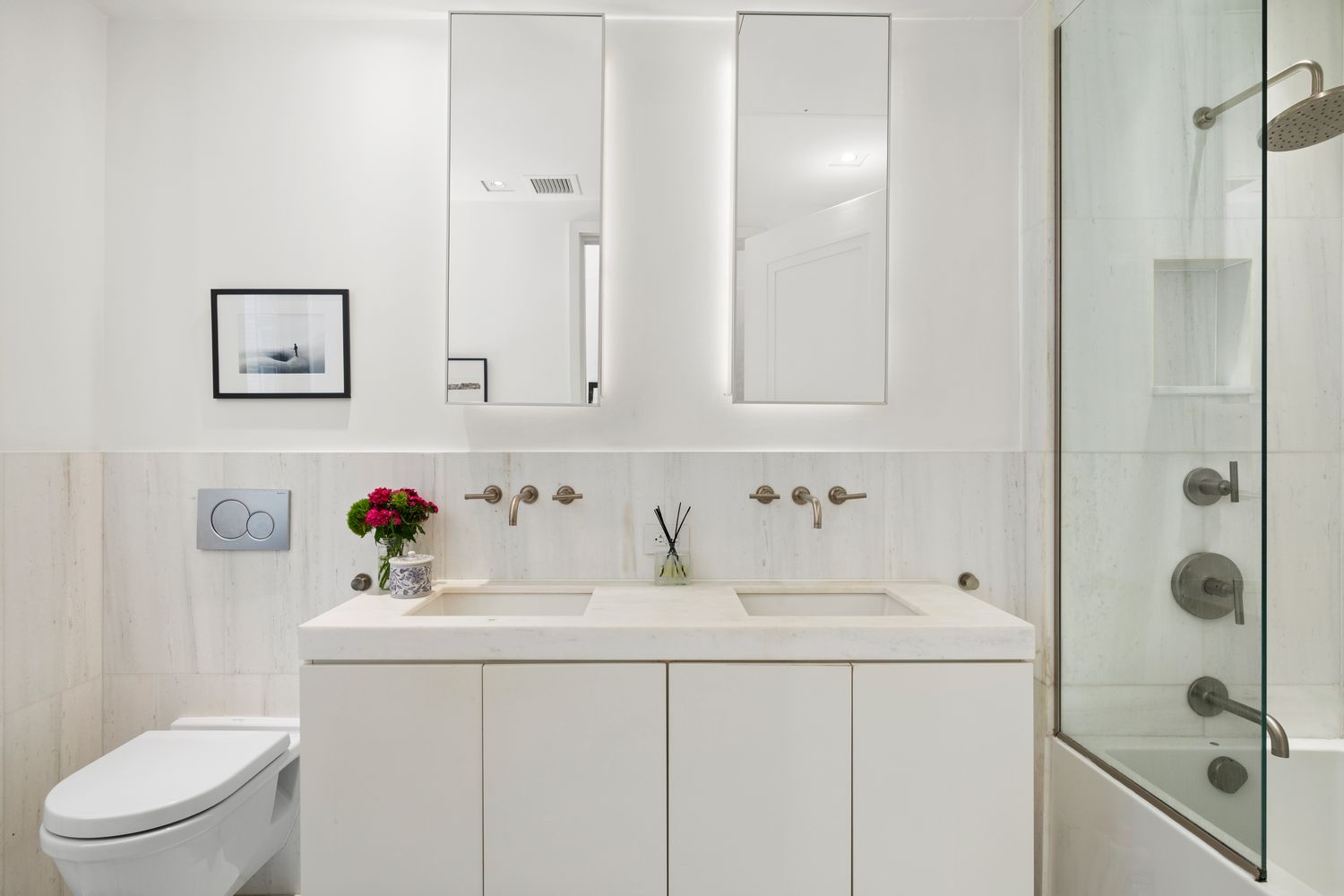 101 Wall Street, Unit 5BE Manhattan, NY 10005 - Photo 6 of 16 a bathroom with a sink vanity mirror and toilet