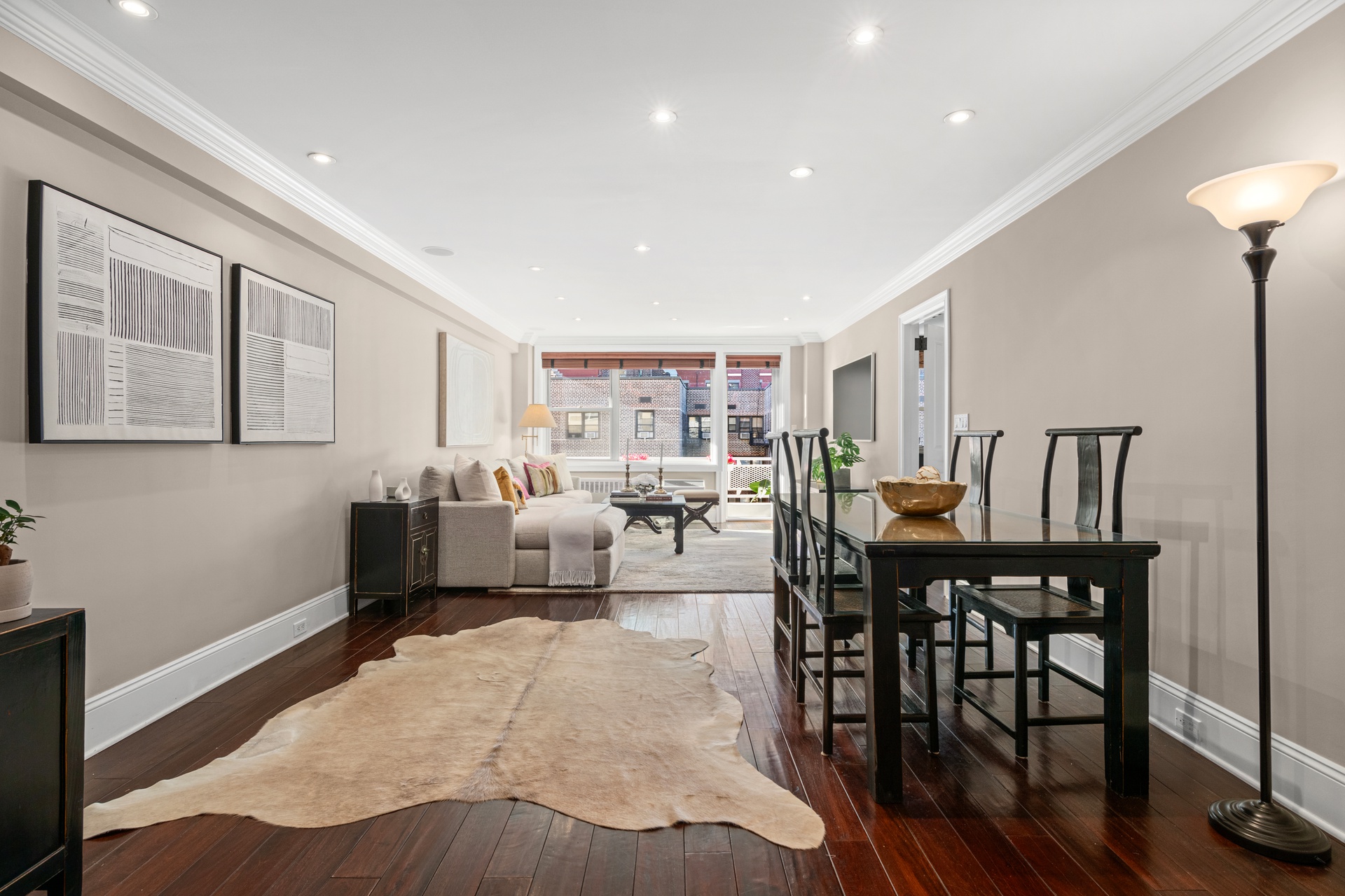 40 East 9th Street, Unit 6M Manhattan, NY 10003 - Photo 6 of 22 a living room with furniture and wooden floor