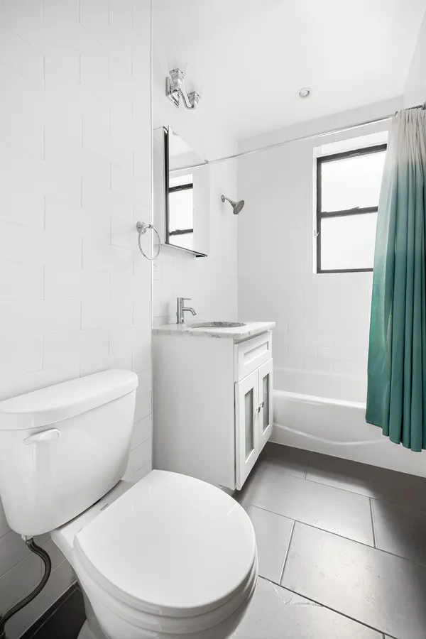 a white toilet sitting next to a bathroom sink