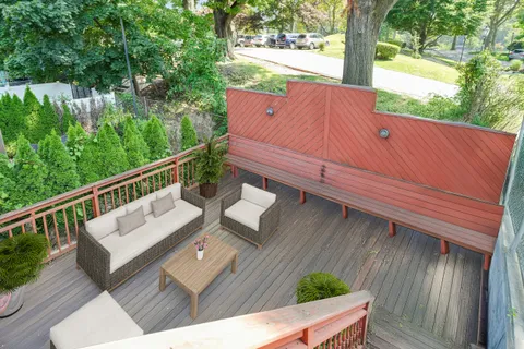 a view of a two chairs in the balcony