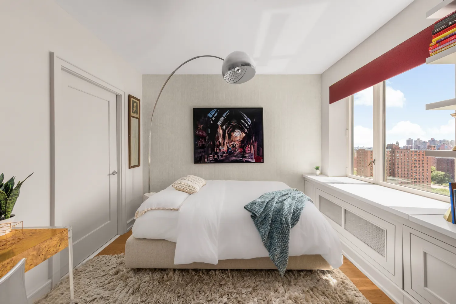 a bed sitting in a bedroom next to a window