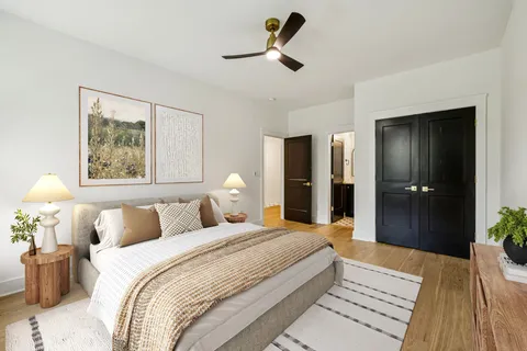 a bedroom with a bed and a chandelier