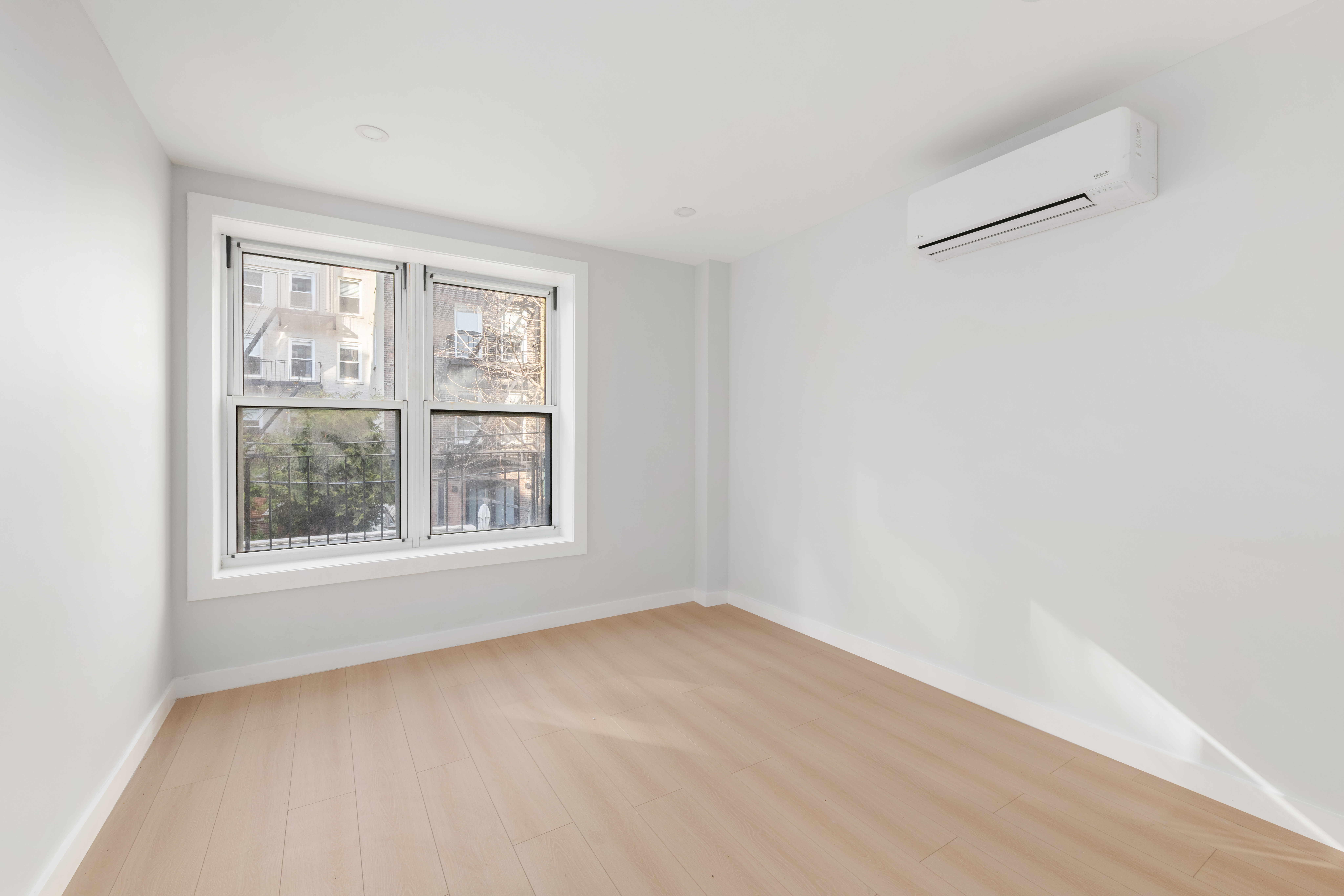 227 East 21st Street, Unit 2R Manhattan, NY 10010 - Photo 5 of 12 an empty room with a window