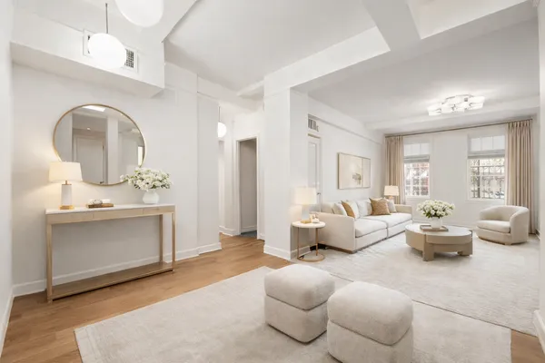 a living room with furniture or couch and a dresser