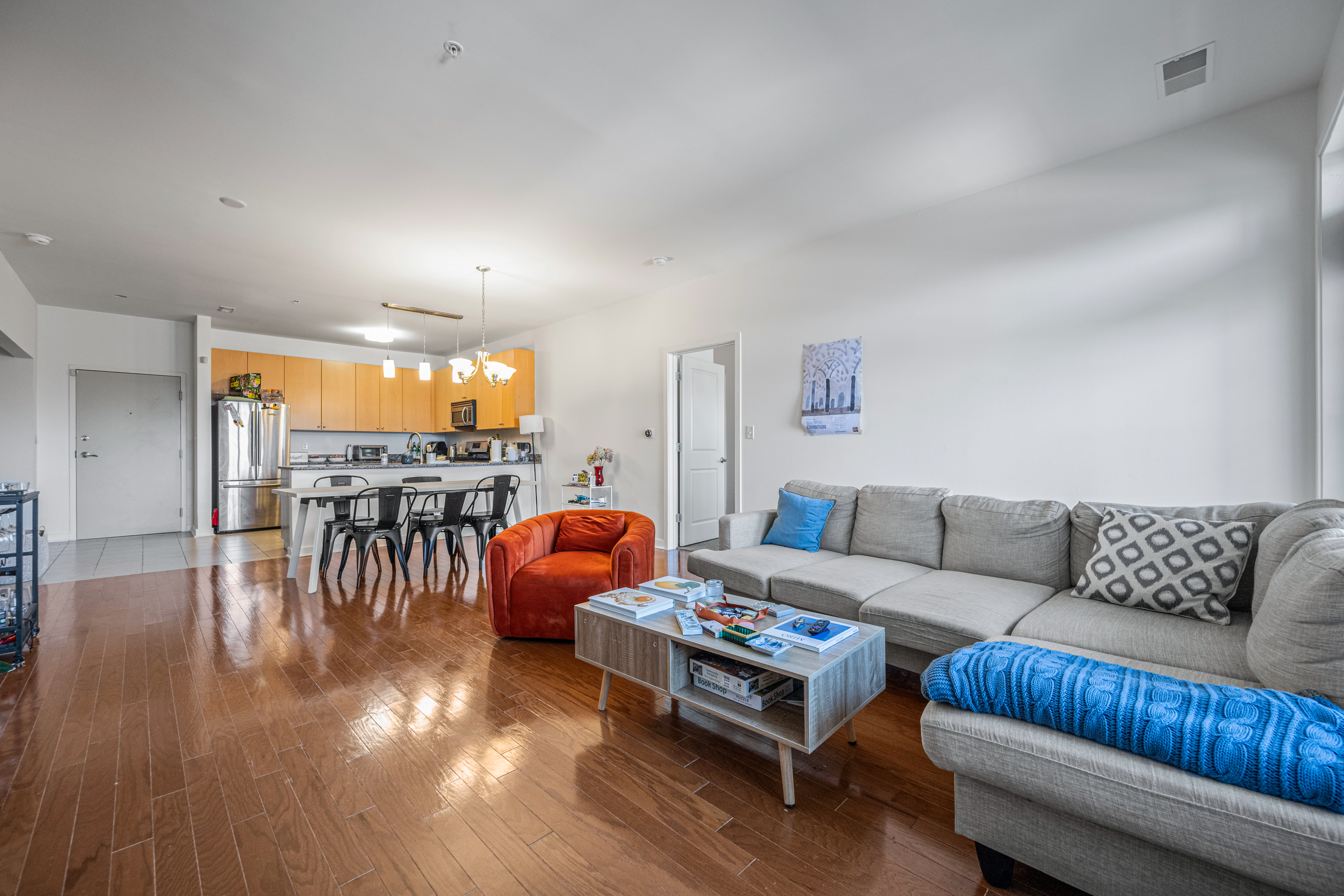 3201 St Paul Street, Unit 310 Baltimore, MD 21218 - Photo 18 of 20 a living room with furniture and kitchen view