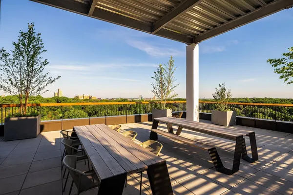 an outdoor sitting area with furniture and city view