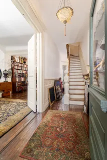 a view of a bedroom with wooden floor and stairs