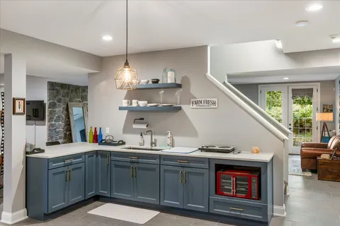 a kitchen with a sink cabinets and wooden floor