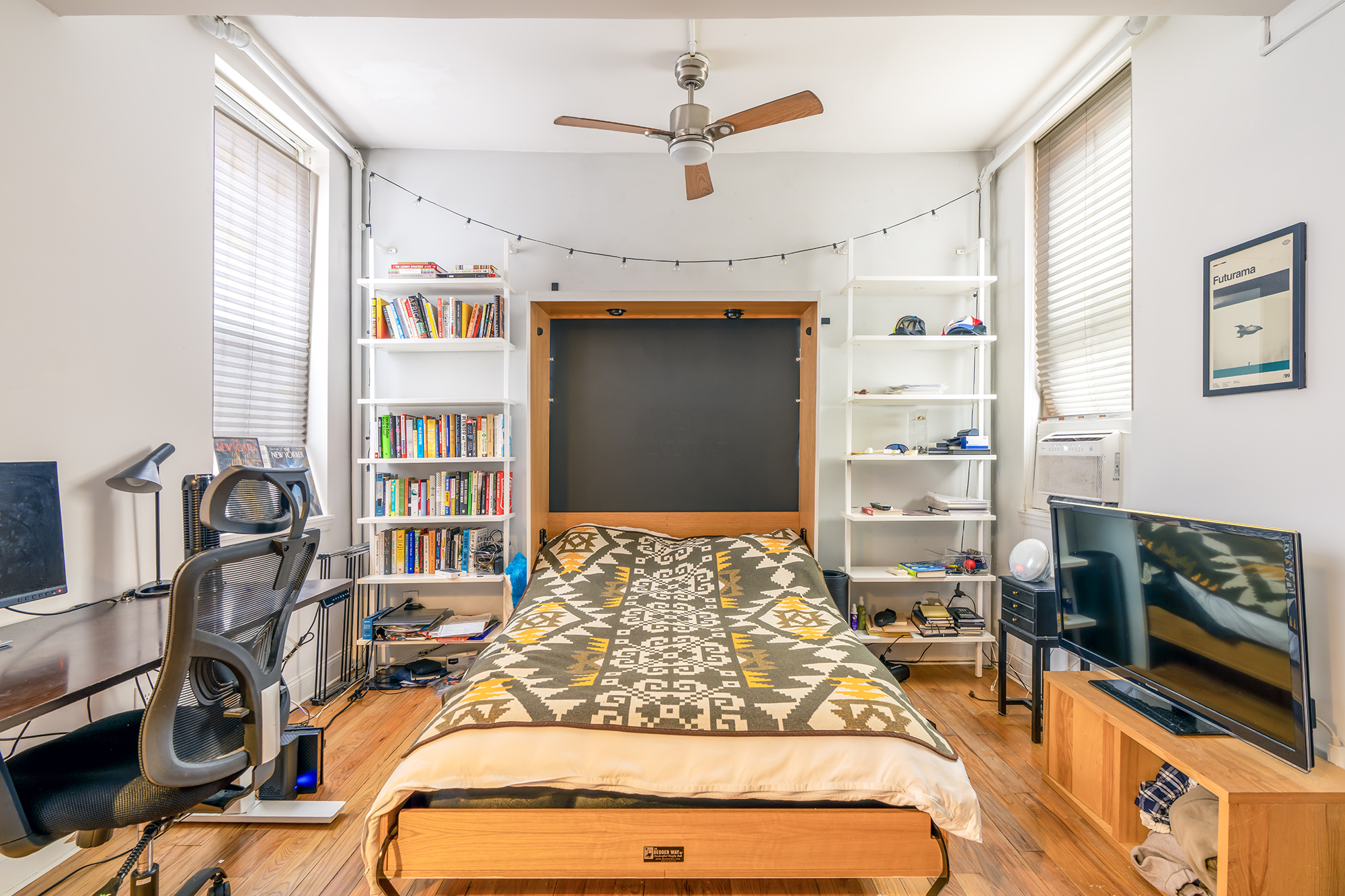 439 Hicks Street, Unit 1B Brooklyn, NY 11201 - Photo 3 of 7 a bed sitting in a bedroom next to a window with a flat screen tv and dresser