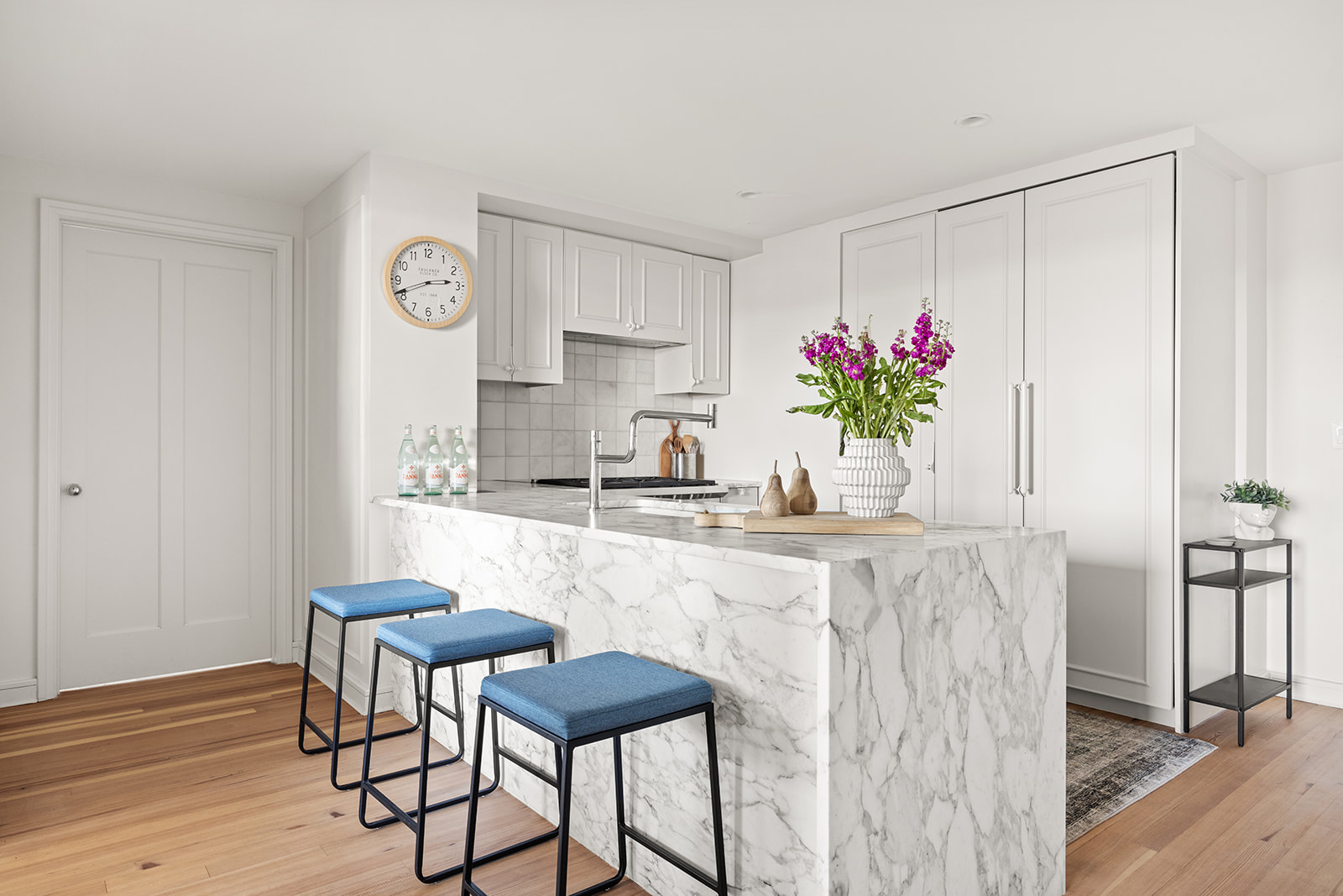 1 Prospect Park West, Unit 8C Brooklyn, NY 11215 - Photo 2 of 11 a kitchen with granite countertop white cabinets and chandelier