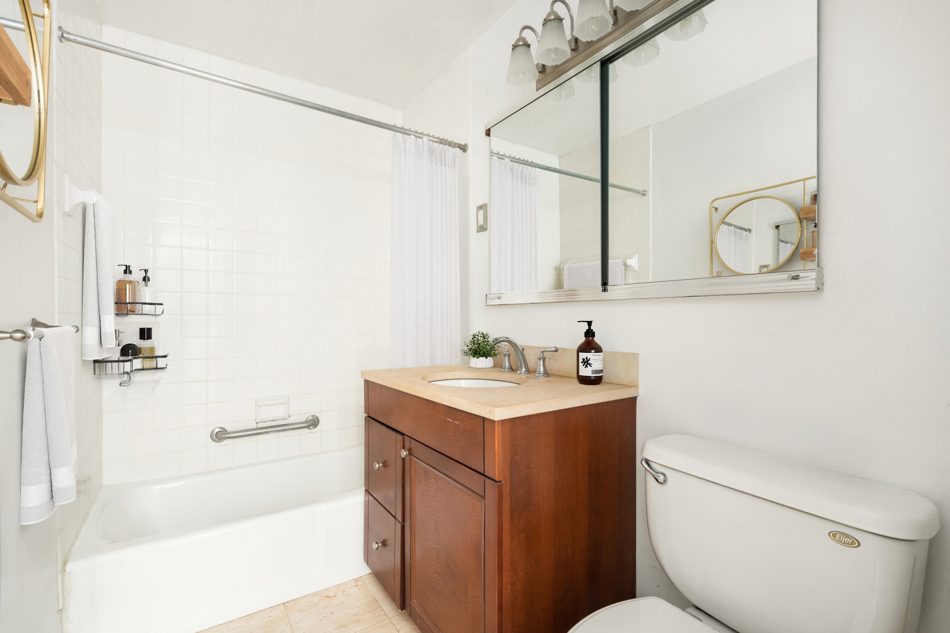 61 East 77th Street, Unit 9C Manhattan, NY 10075 - Photo 10 of 11 a bathroom with a granite countertop sink toilet and shower