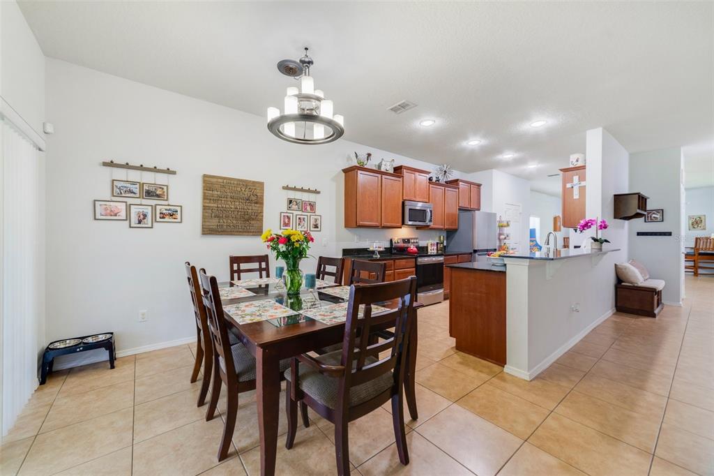 352 Giovani Boulevard Clermont, FL 34715 - Photo 11 of 46 a view of a dining room with furniture and a kitchen