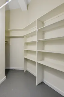 a view of room and empty shelves