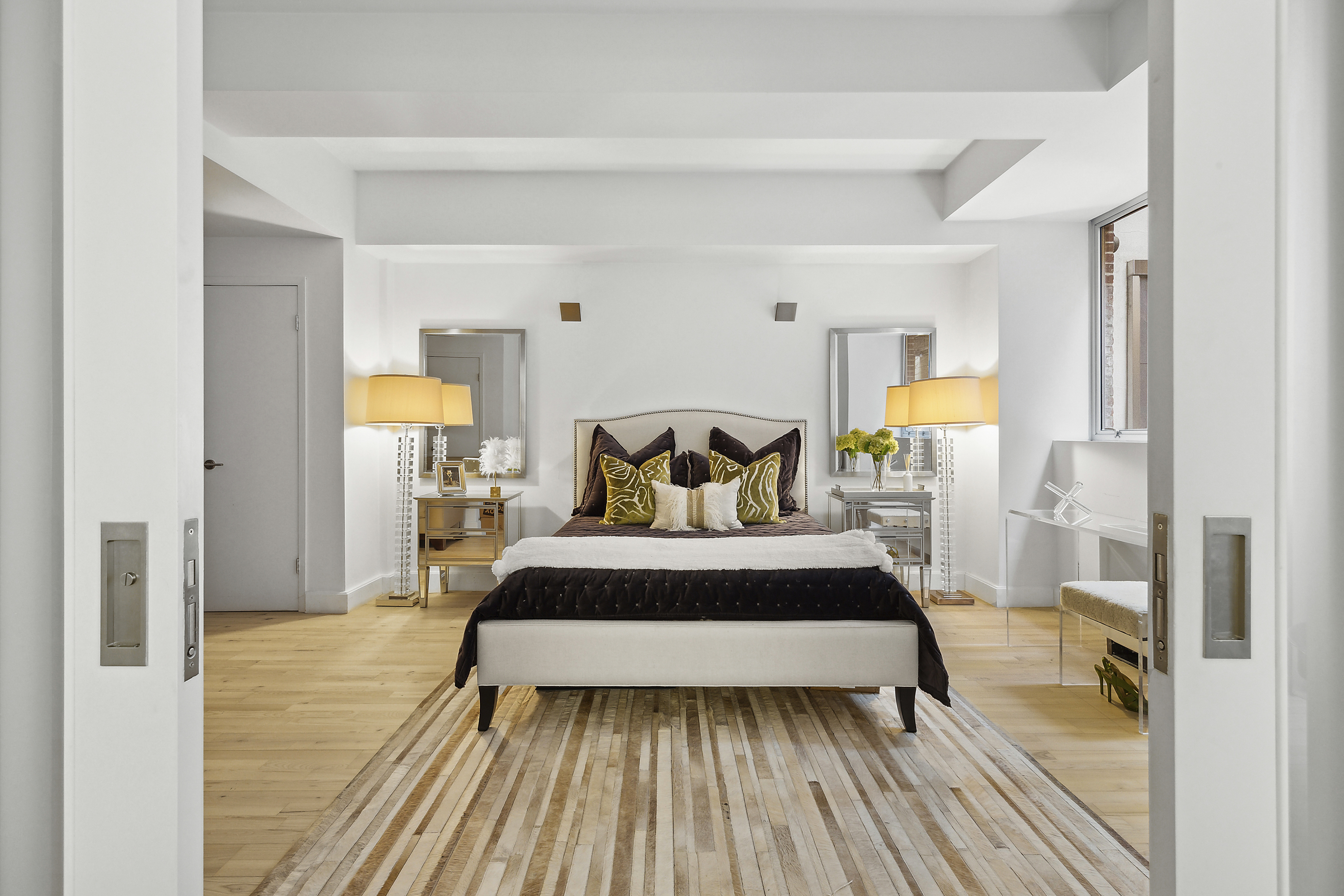 420 West 25th Street, Unit TH1E Manhattan, NY 10001 - Photo 12 of 22 a bedroom with a bed and wooden floor