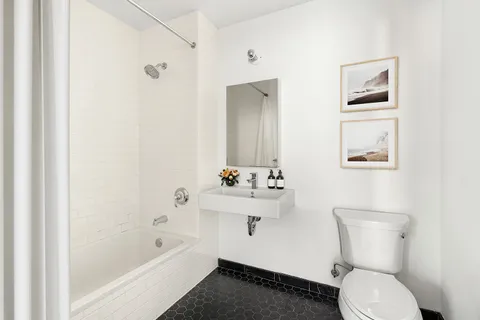 a bathroom with a toilet a sink and bathtub