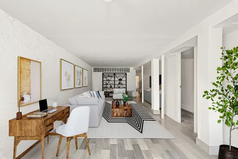 a living room with furniture and a potted plant