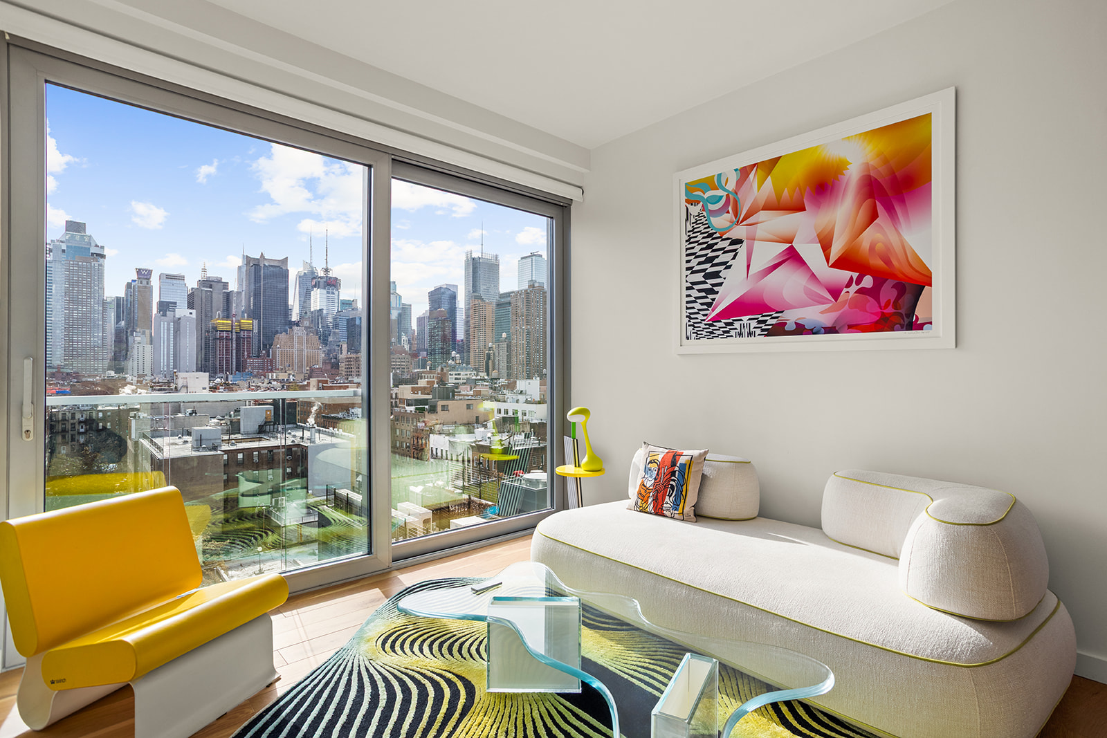 a living room with furniture and a floor to ceiling window