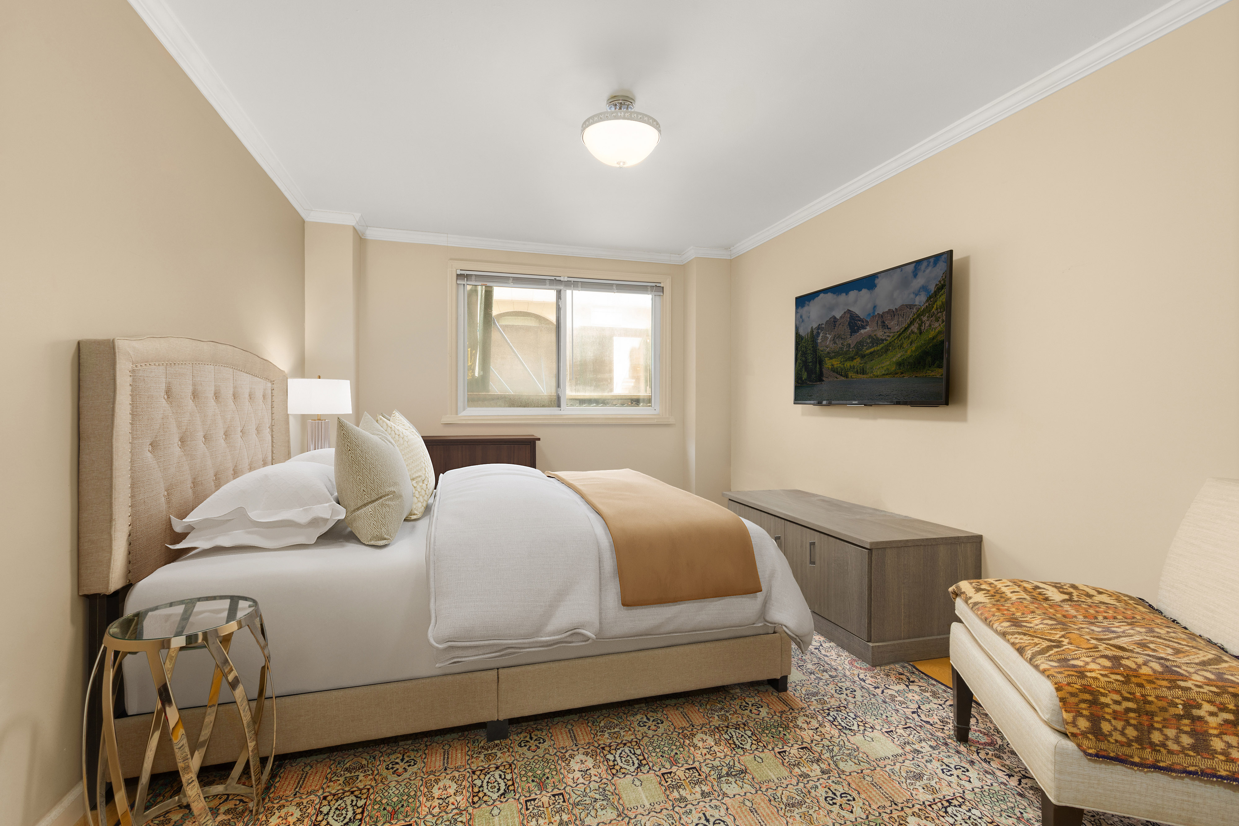 7 East 35th Street, Unit 2E Manhattan, NY 10016 - Photo 4 of 10 a bedroom with a bed and a flat screen tv