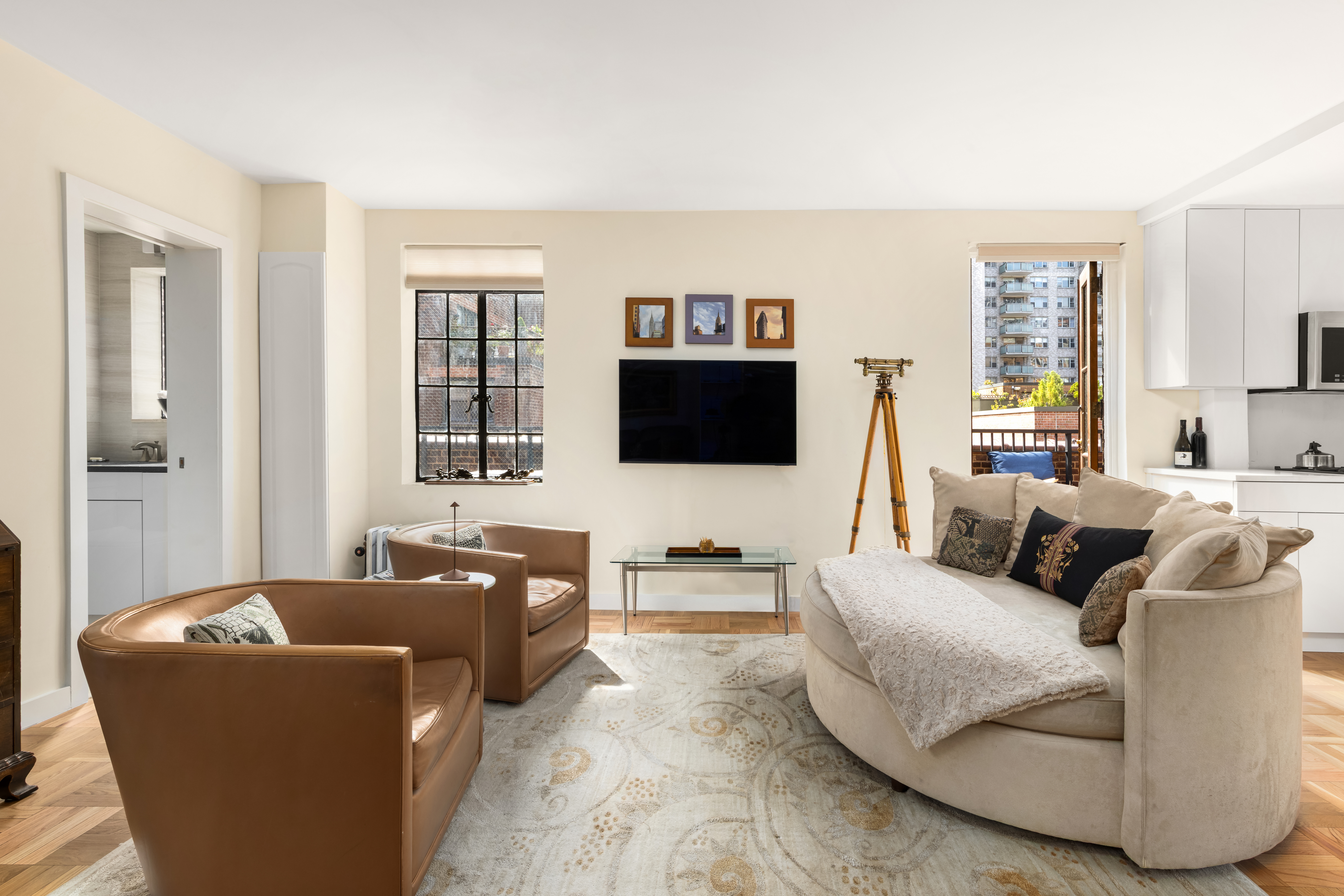 324 East 41st Street, Unit 1103C Manhattan, NY 10017 - Photo 8 of 13 a living room with furniture and a flat screen tv
