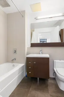 a spacious bathroom with a bathtub sink and toilet