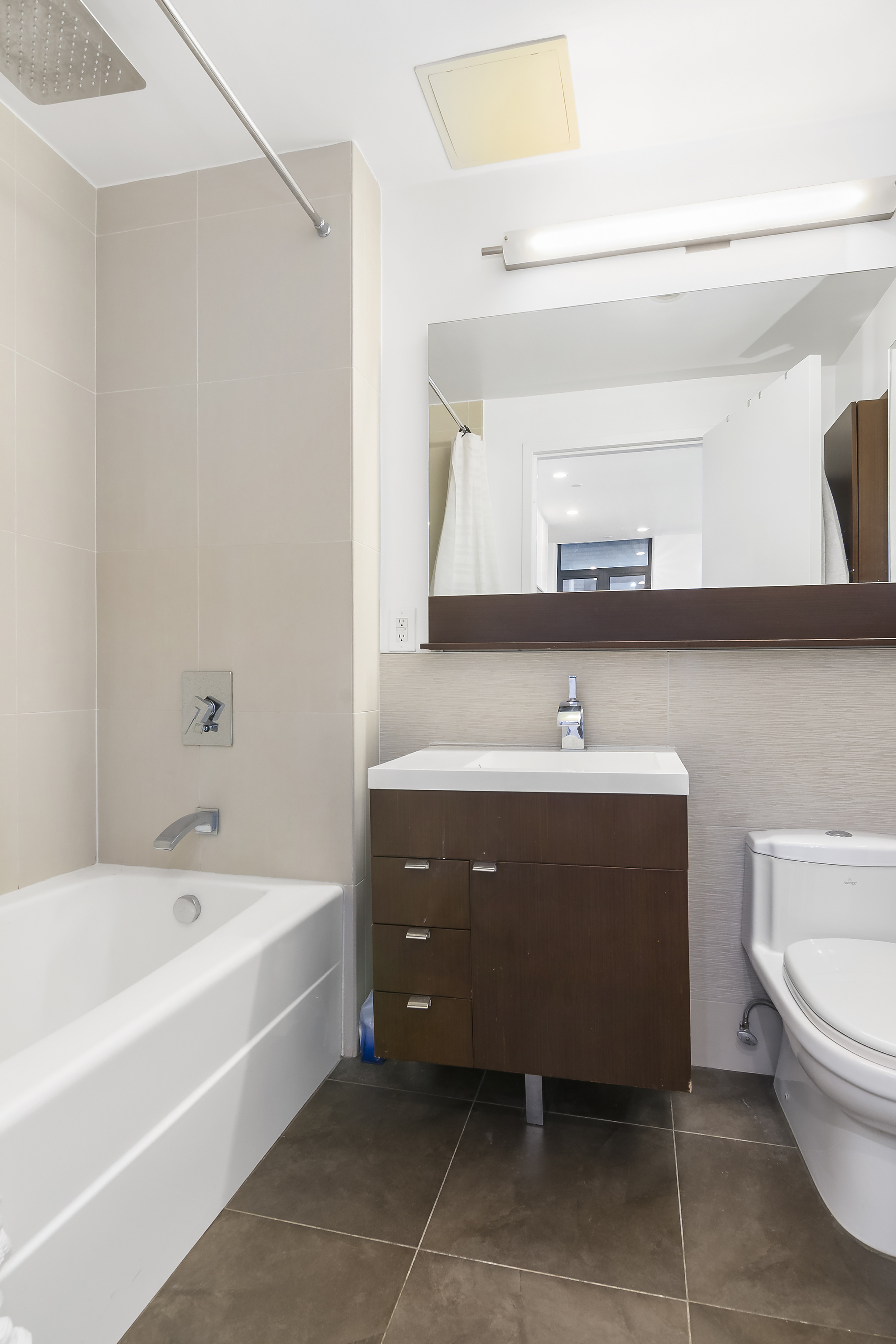 148 East 24th Street, Unit 3F Manhattan, NY 10010 - Photo 8 of 9 a spacious bathroom with a bathtub sink and toilet