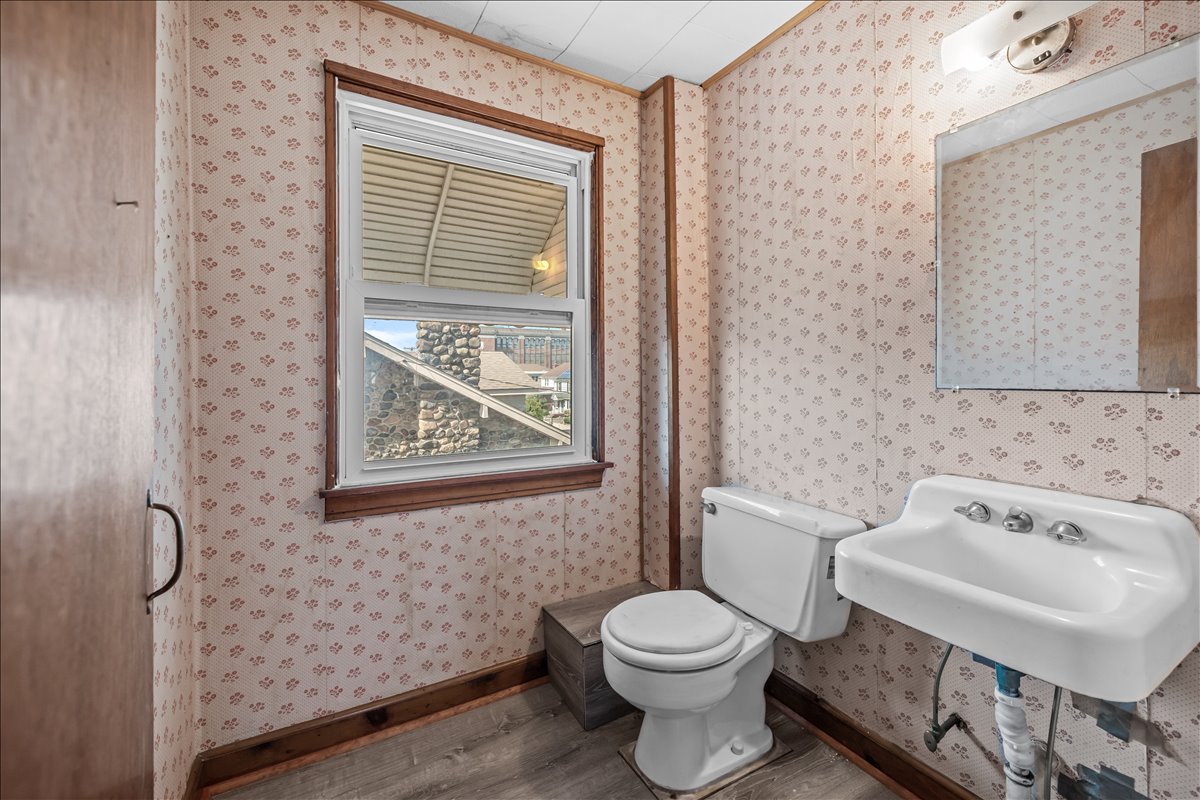 100-14 159th Avenue Queens, NY 11414 - Photo 17 of 26 a bathroom with a toilet and a sink