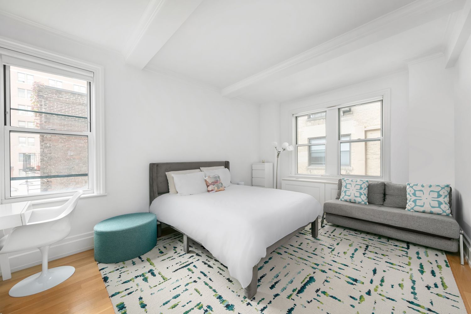 a bedroom with a bed and a large window