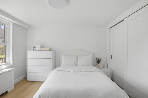 a bedroom with a bed and a dresser