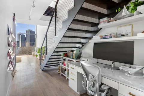 a view of a livingroom with furniture and staircase
