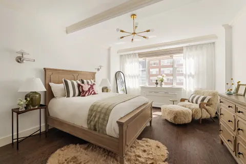 a bedroom with bed and window